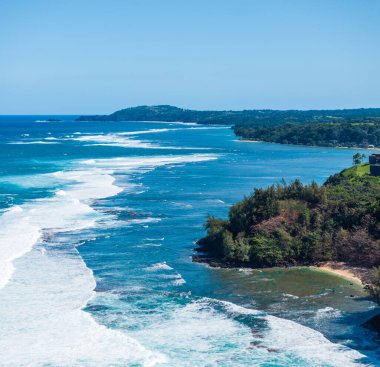 Drone aerial view of Princeville resorts and Sealodge beach to Kilauea point clipart