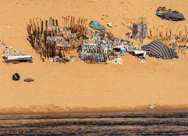 Aswan yakınlarındaki Nubian köyünde Nil Nehri kıyısındaki kumlu sahilde Mısır hediyeleri ve ıvır zıvır koleksiyonu.