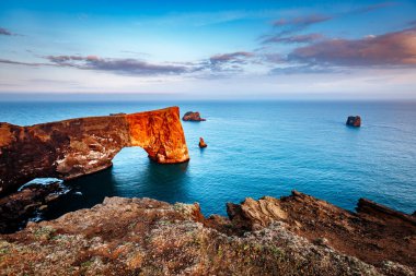 Şaşırtıcı siyah kemer lav duran küçük Yarımadası'nda denizin içinde. Popüler turistik. Sıradışı ve muhteşem sahne. Konumu Sudurland, cape Dyrholaey, sahil İzlanda, Europe. Güzellik dünya.