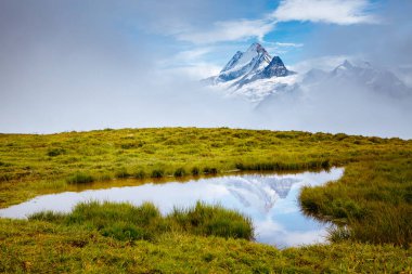 Great view of the snow rocky massif. Popular tourist attraction. Dramatic and picturesque scene. Location place Bachalpsee in Swiss alps, Grindelwald valley, Bernese Oberland, Europe. Beauty world.