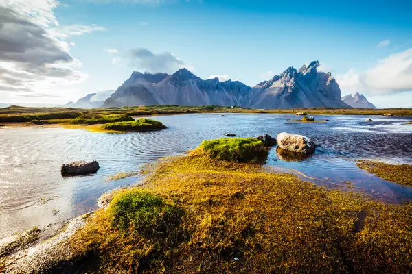 Güneş ışığıyla parlayan sıra dışı tepelerin çarpıcı görüntüsü. Egzotik ve muhteşem bir sahne. Konum Stoksnes Pelerini, Vestrahorn (Mt. Batman), İzlanda, Avrupa. Nefes kesici duvar kağıdı. Güzellik dünyası.