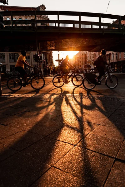 Berlin, people cycling city urban scene silhouette at sunset - Busy street in Berlin, capital city of Germany, with unrecognisable people - travel and transport