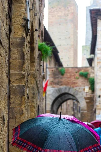 Frustrated Tourists Rain Umbrellas Seeing Sights San Gimignano Italy Stock Image