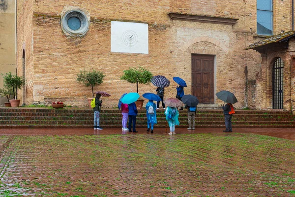 Frustrated Tourists Rain Umbrellas Seeing Sights San Gimignano Italy Stock Photo