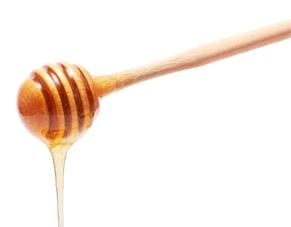 白い背景に黄金の新鮮な蜂蜜と木製の棒 — ストック写真
