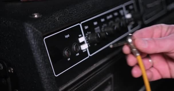 Male Hand Plugging Guitar Cord Cable Input Jack Amplifie — Vídeos de Stock