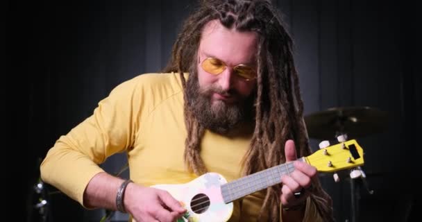 Guitarist Man Plays Ukulele Guitar Close Studio — Stock video