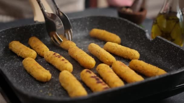 Woman Puts Cheese Sticks Hot Oiled Grill Frying Pan — Stockvideo