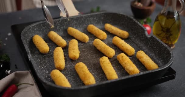 Woman Puts Cheese Sticks Hot Oiled Grill Frying Pan — Stockvideo