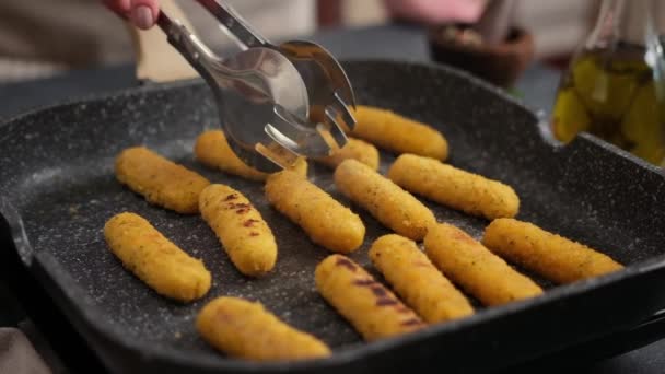 Woman Puts Cheese Sticks Hot Oiled Grill Frying Pan — Stock video