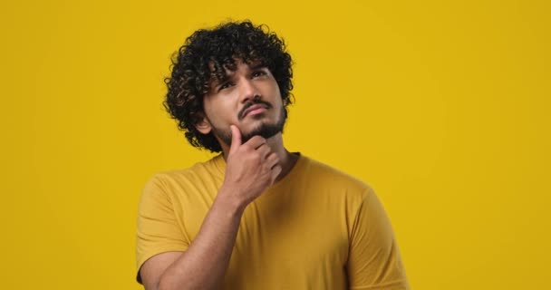 Pensive Ung Indian Man Tänker Med Handen Nära Hakan Stående — Stockvideo