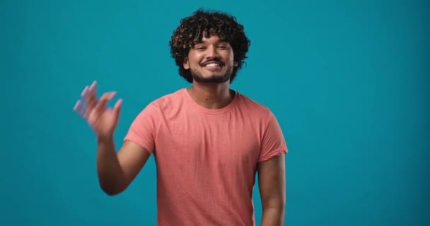 Молодой Индиец Удовлетворен Счастливым Парнем Показывающим Жест Бинокля Фоне Синей — стоковое видео