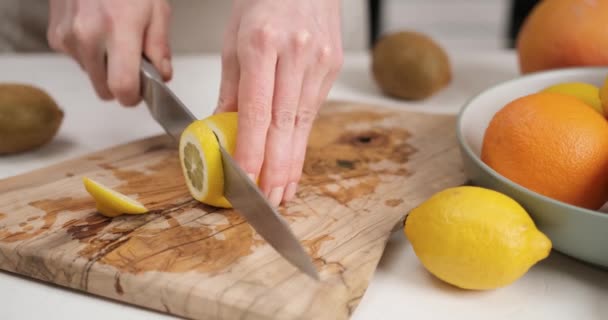 女性はナイフでスライス木製のまな板の上に新鮮な有機レモン Dci 二重スローモーション — ストック動画