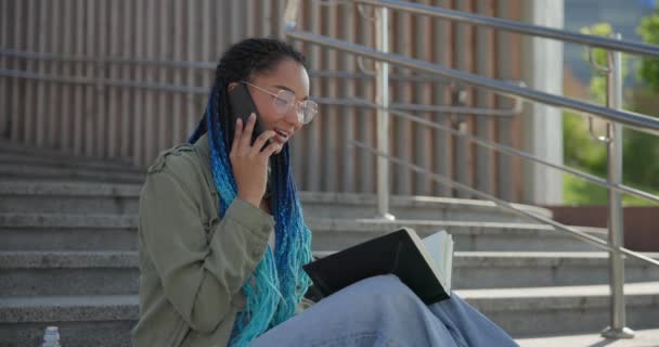 Genç Afrikalı Amerikalı Kız Öğrenci Telefonda Konuşuyor Dışarıda Merdivenlerde Oturmuş — Stok video
