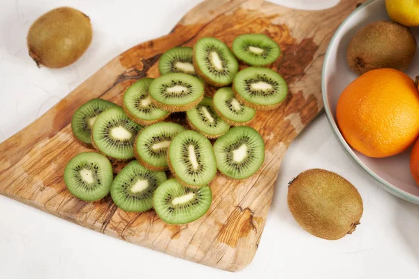 Stock image Fresh Sliced organic kiwi on wooden cutting board.