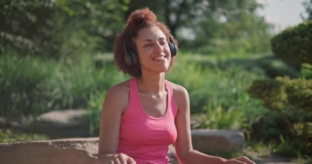 Młoda Afroamerykanka Słuchająca Muzyki Patrząca Telefon Ćwicząca Jogę Świeżym Powietrzu — Wideo stockowe