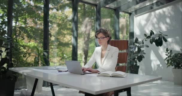 Young Caucasian Woman Wearing Glasses Working Laptop Bright Modern Design — Stock Video