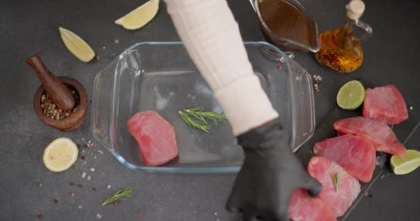 Woman Putting Pieces Organic Pink Raw Tuna Steak Glass Dish — Stock Video