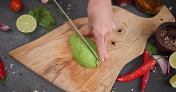 女人们在自家厨房的木板上用刀切新鲜的绿色鳄梨果 Dci — 图库视频影像