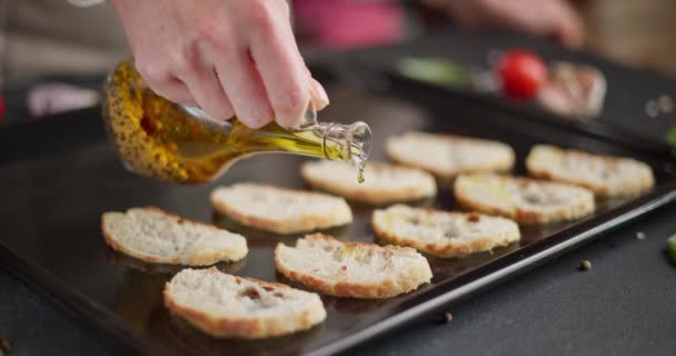 Woman Pours Olive Oil Sliced Baguette Pieces Baking Tray Making — Stock Video