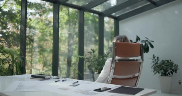若い白人ビジネス女性労働者は 仕事休憩を終えたオフィスの椅子に座っています — ストック動画