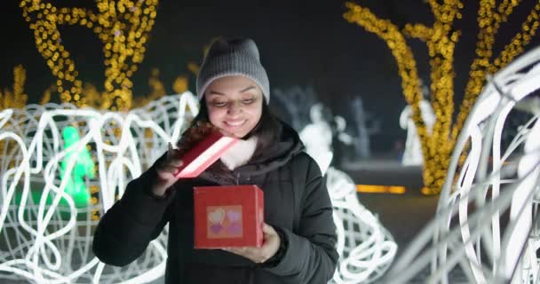 Jovem Mulher Indiana Abre Caixa Presente Com Arco Sobre Guirlandas — Vídeo de Stock