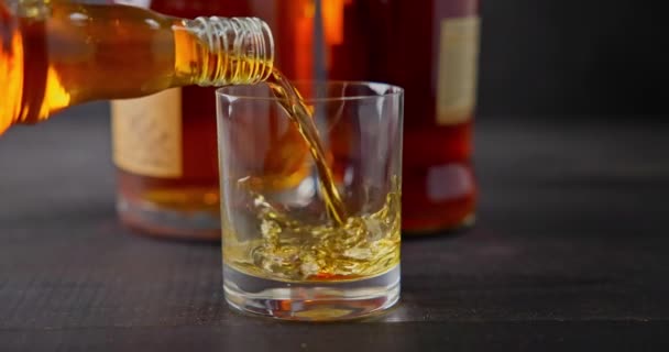 Bartender Pours Whiskey Glass Goblet Background Bottles Dci Slow Motion — Stock Video