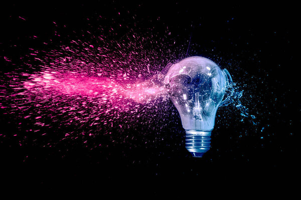 blue and red electric bulb shattering on black background