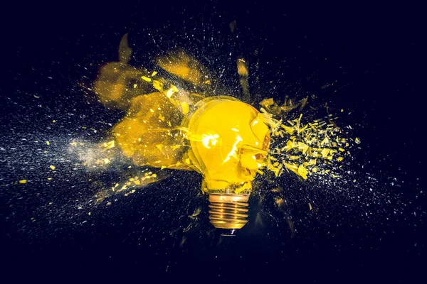 Yellow Filament Bulb Destroying Black Background — Stock Photo, Image