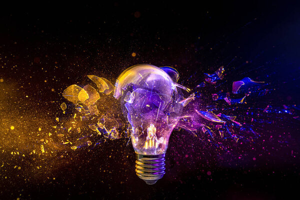 light bulb shattering on black background. concept of creativity and innovation