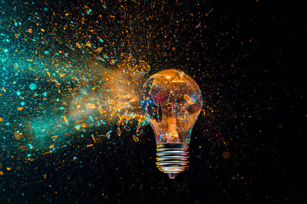 lightbulb exploding  colorful powder black background creativity innovation concept