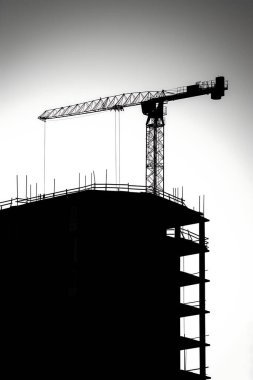 Crane builds a building, construction site, silhouette photo. Minimalism clipart