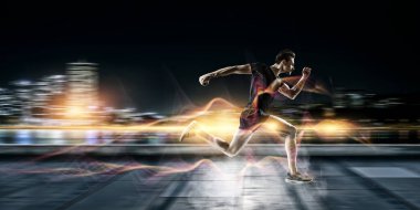 Spor giyimli bir adam spor için koşuyor, spor yapıyor ve sağlıklı bir yaşam sürüyor. Karışık ortam