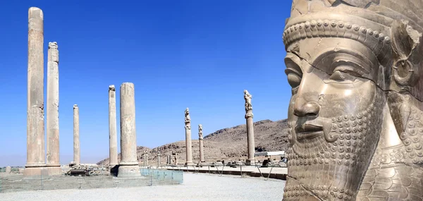 Horizontal banner with columns of Apadana Palace built by Darius the Great and face of assyrian protective deity lamassu - human-headed winged bull, Persepolis, Iran. UNESCO world heritage site