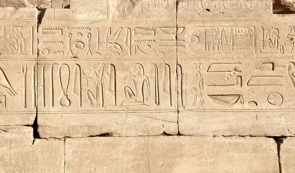 Ancient Egyptian hieroglyphs on stone wall, Karnak Temple Complex, Luxor, Egypt, Africa. Stone carvings with hieroglyphs at Karnak temple, Luxor, Thebes