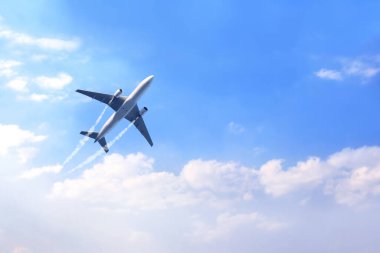 Horizontal nature background with aircraft and Jet trailing smoke in the sky. Airplane and condensation trail. Foggy trail jet and plane in blue sky with white clouds. Traveling the world concept clipart