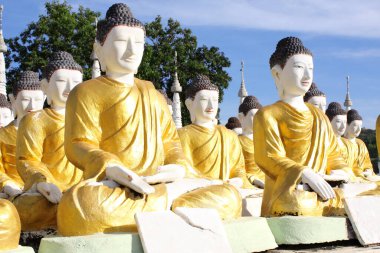 Rows of old stone statues of Buddha, Aung Setkya Paya, near to famous Bodhi Tataung temple complex, Monywa, Sagaing Region, Myanmar (Burma) clipart