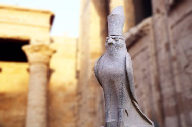 Granite statue of God Horus falcon at entrance Temple of Horus, Edfu, Egypt. Famous landmark ptolemaic Horus Temple in Idfu (Edfou, Behdet), Egypt clipart