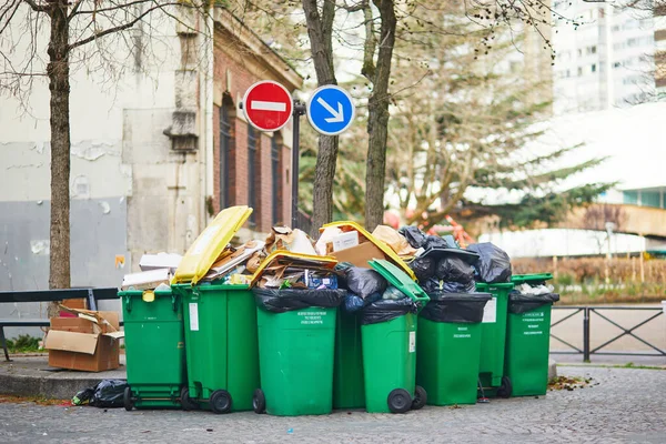 stock image Paris, France - March 16, 2023: Messy streets with overfull garbage bins during binmen strike in Paris, France.