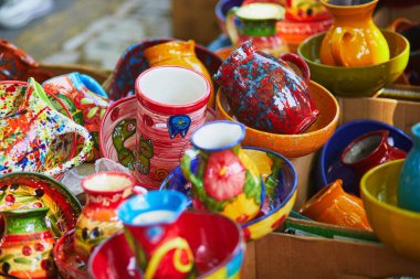 Colorful clay crockery on a farmer market in Cucuron, Provence, France