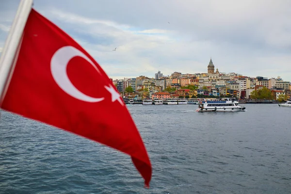 View of Istanbul, Turkey with Turkish flag and Galata tower over Bosphorus Strait