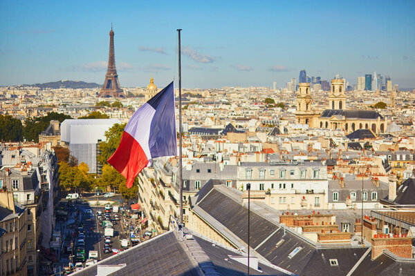 Scenic Parisian cityscape. Aerial view of the Eiffel tower over the French flag in Paris, France
