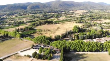Aerial scenic Mediterranean landscape with cypresses, olive trees and vineyards in Provence, Southern France