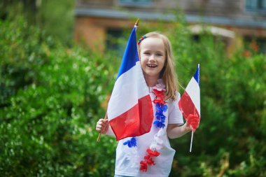 Fransız milli bayrağıyla sevimli anaokulu kızı yarışma sırasında milli takımını destekliyor ve tezahürat yapıyor.