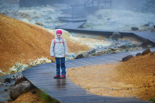 stock image Adorable preschooler girl having fun in Krysuvik and Seltun geothermal area in Iceland