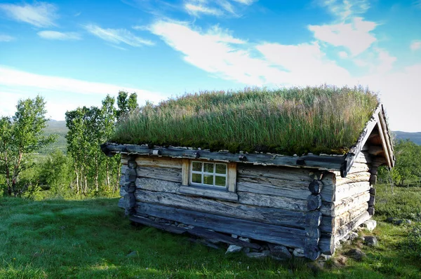 View of a small wooden house on a hill in Norway.