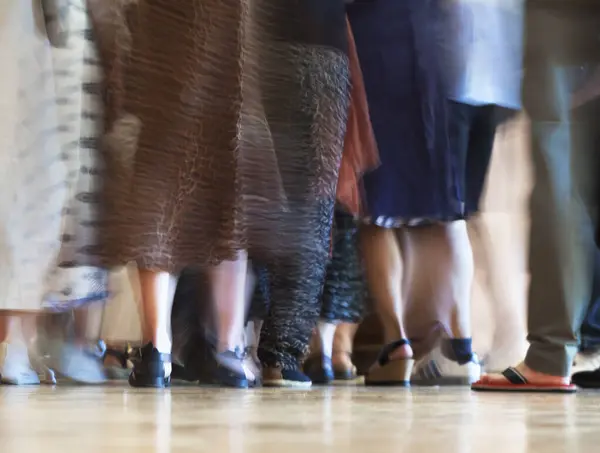 stock image A crowd of people is walking forward on the surface of the floor.