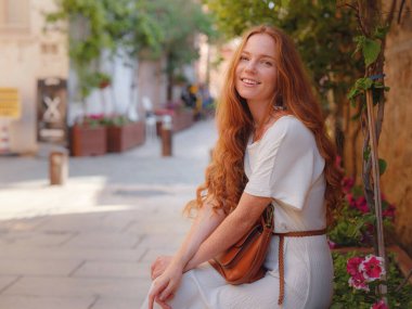 Antalya sokaklarının arka planında mutlu bir kadın turist. Kadın turist ilginç yerler ve popüler yerler keşfediyor ve Türkiye 'nin Antalya kentindeki eski Kalechi kentinde yürüyor.