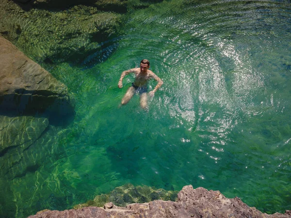 Turkey travel, mediterranean area on a warm summer day. Young man dive and have fun in mountain river. Concept of living open air, Travel , active lifestyle, summer vacation.