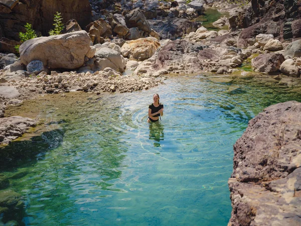Turkey travel, mediterranean area on a warm summer day. Young woman in swimsuit have fun in mountain river. Concept of living open air, Travel , active lifestyle, summer vacation.